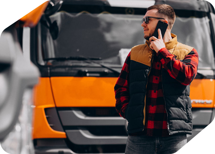 Person in casual attire standing near a truck, with a graphical display of performance metrics.